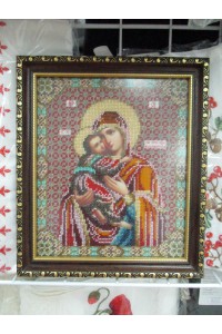 The icon of the Mother of God is embroidered with beads and a frame