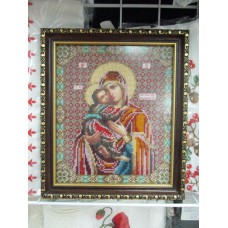 The icon of the Mother of God is embroidered with beads and a frame