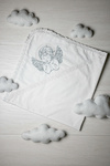 White baptismal blanket with silver embroidery of an Angel