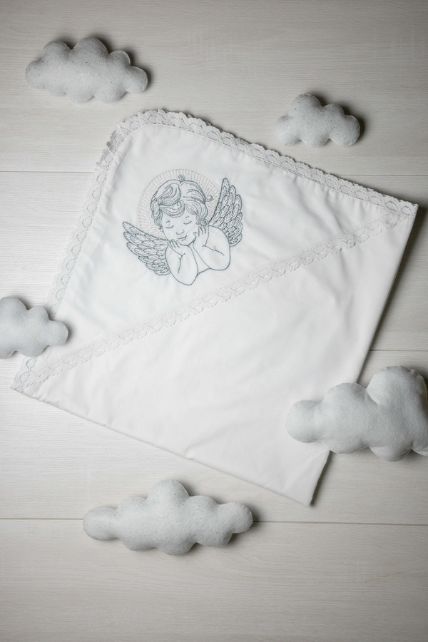 White baptismal blanket with silver embroidery of an Angel
