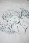 White baptismal blanket with silver embroidery of an Angel