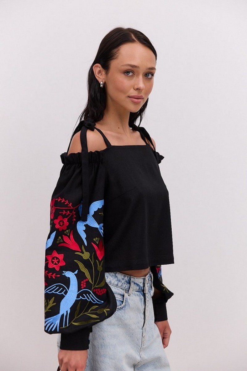 Black embroidered shirt with open shoulders and long sleeves May