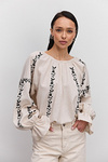 Women's embroidered blouse in light beige melange with black satin-stitched flowers