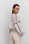 Women's embroidered blouse in light beige melange with black satin-stitched flowers
