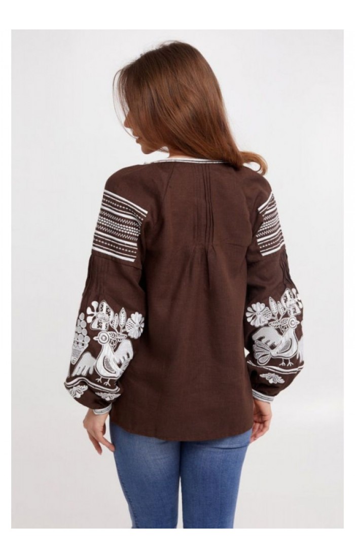 "Nizhana, a women's embroidered shirt of a brown color with white embroidery."
