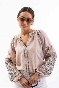 Women's embroidered blouse light beige with smooth flowers on the sleeves. Spring.