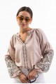 Women's embroidered blouse light beige with smooth flowers on the sleeves. Spring.