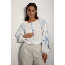Women's embroidered shirt with  blue swallows on white.