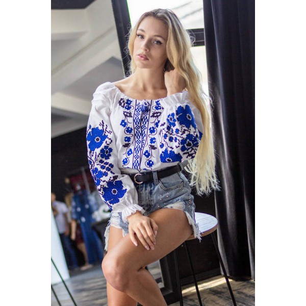 Spring dreams, a white embroidered shirt with blue flowers on the sleeves and chest.