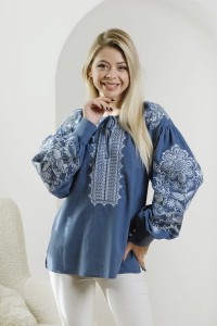 Blue embroidered shirt with white embroidery.