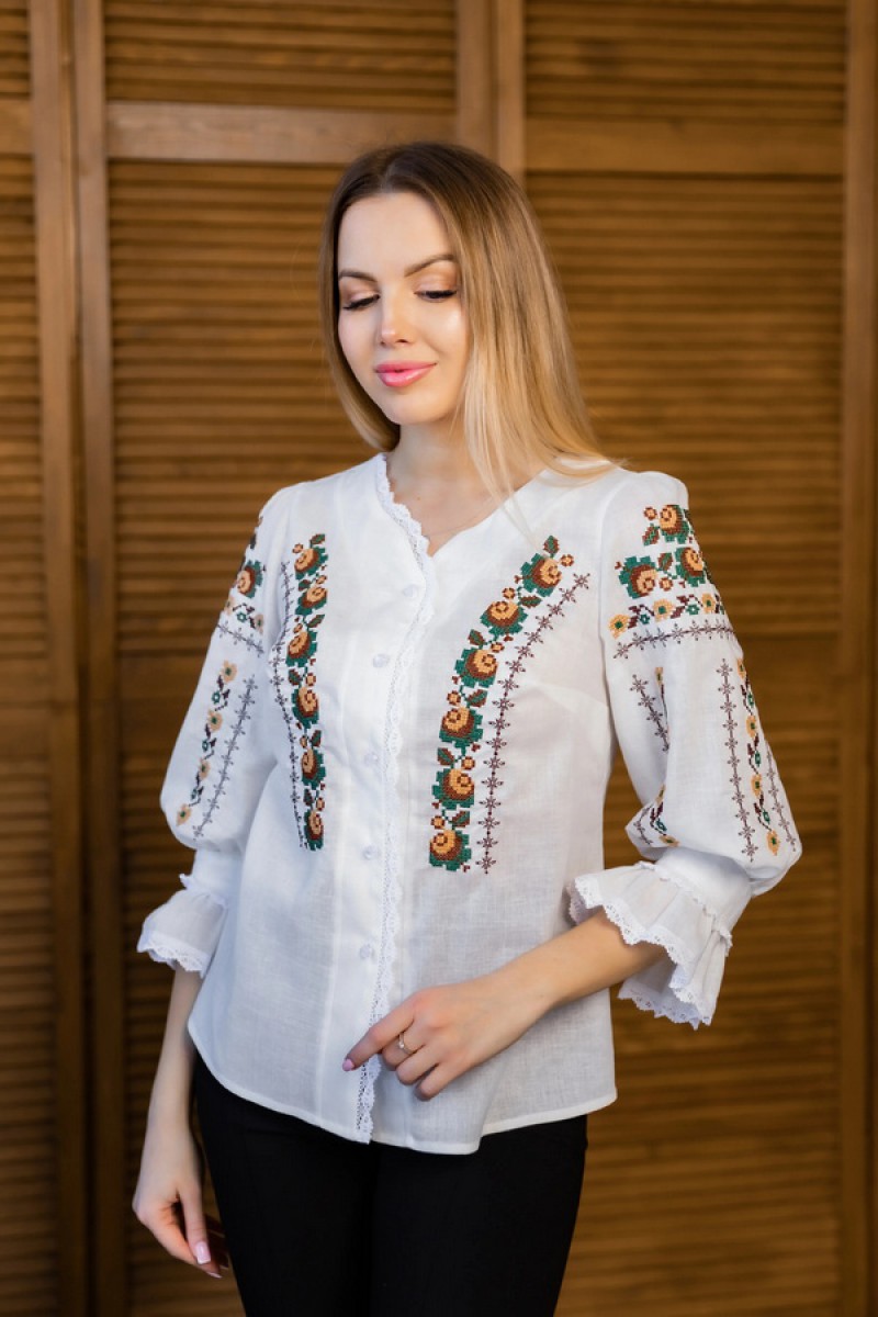 Women's milk embroidered shirt with gold embroidered neckline.