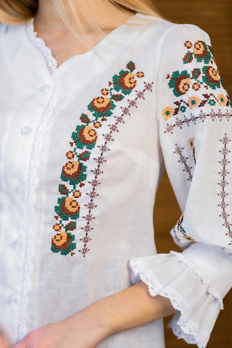 Women's milk embroidered shirt with gold embroidered neckline.