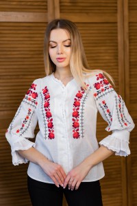 Women's milk embroidered shirt with gold embroidered neckline.