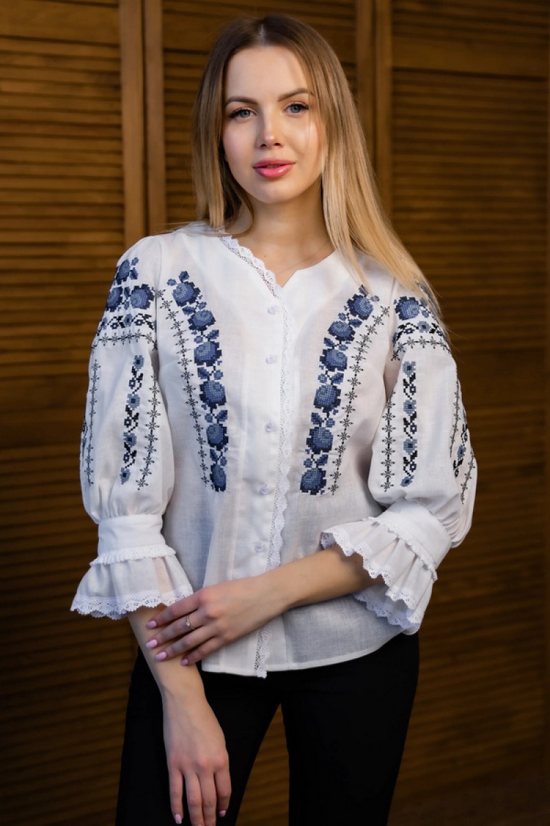 Women's milk embroidered shirt with gold embroidered neckline.
