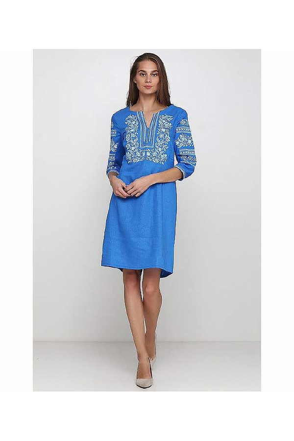 The rose is blue the embroidered dress is feminine