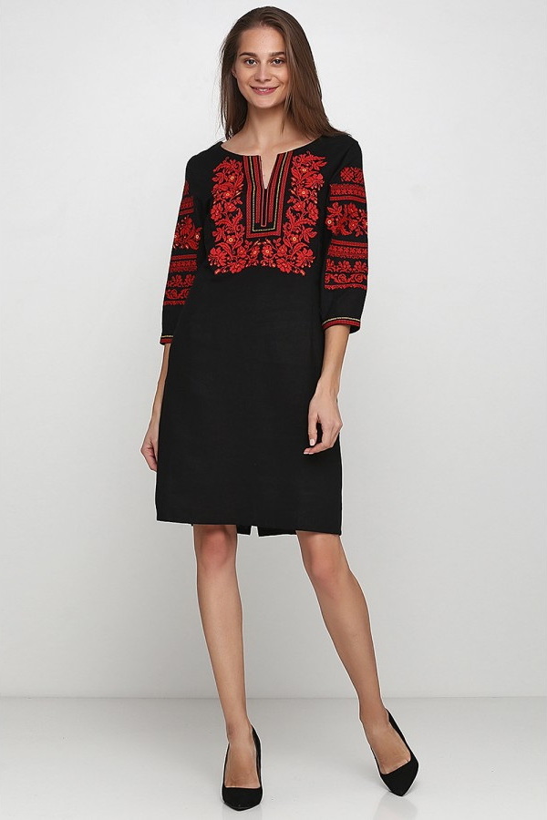 The rose is red the embroidered dress is feminine