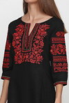 The rose is red the embroidered dress is feminine